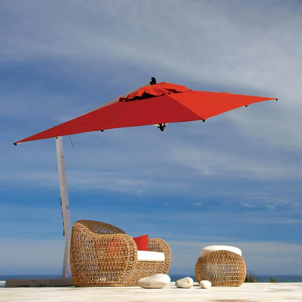 pop of color: 9.8" picollo square cantilever umbrella in red tilted to protect from the sun