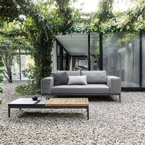 grid sofa with 60" coffee table (teak/ stone top); throw pillows opt. </br><i>image provided courtesy of gloster furniture, inc.</i>