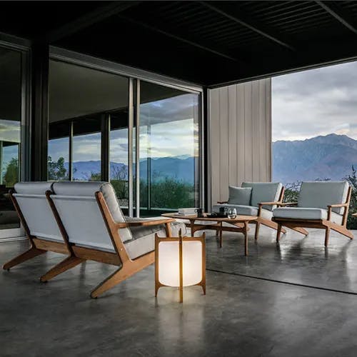 bay 2-seater sofa and two lounge chairs illuminated by gloster's ambient lantern