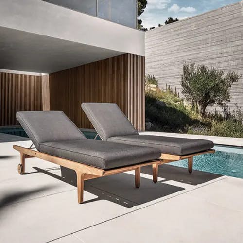 pair of bay loungers with wheels poolside