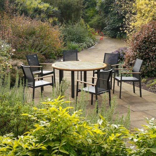 Barlow Tyrie Aura 55" Teak Circular Dining Table with Aura Stacking Armchairs (Graphite)