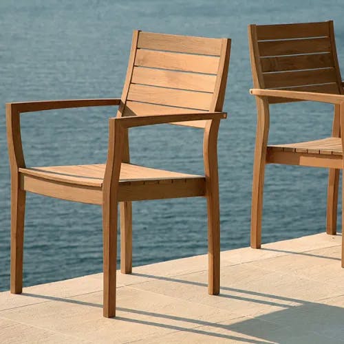 front versus side view: all teak horizon stacking armchairs