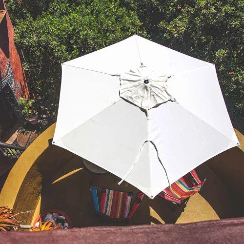hiding from the sun anywhere: easily portable swift round center pole umbrella with sunbrella natural canopy