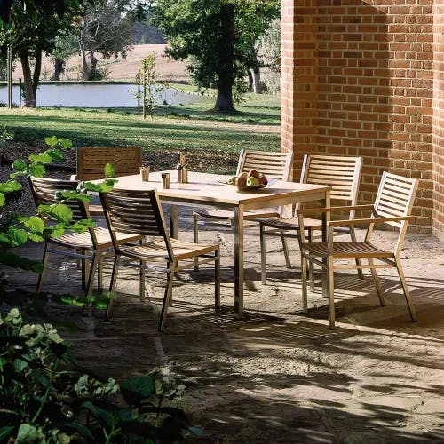classic teak: four teak side chairs surround the equinox 59" teak dining table