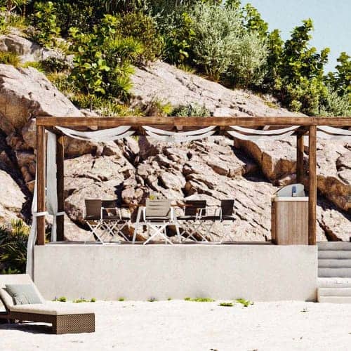 Beachside dining enclave with Sail Taupe armchairs (Courtesy of DEDON)