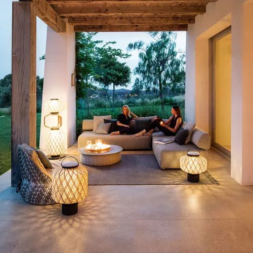 country setting: THE OTHERS lanterns with DALA Lounge Chair, BRIXX seating and PORCINI table (Courtesy of DEDON)