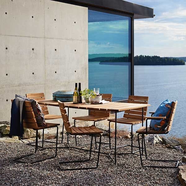 does well on uneven surfaces: one grinda armchair and five grinda side chairs staged with grinda's 59" dining table
