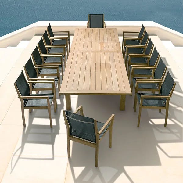 14 horizon stacking armchairs (sling, charcoal) paired with barlow tyrie's apex 106-154" extending dining table
