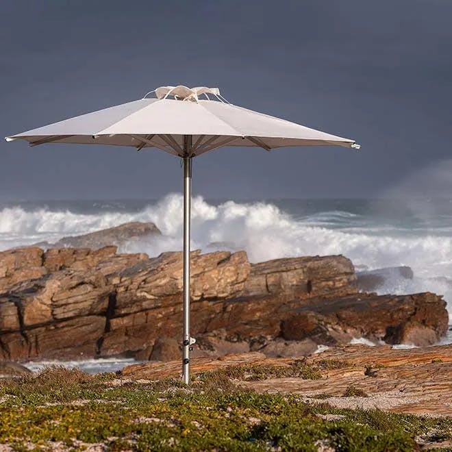 solid as a rock: 11.5' storm round center pole umbrella with sunbrella canopy in natural