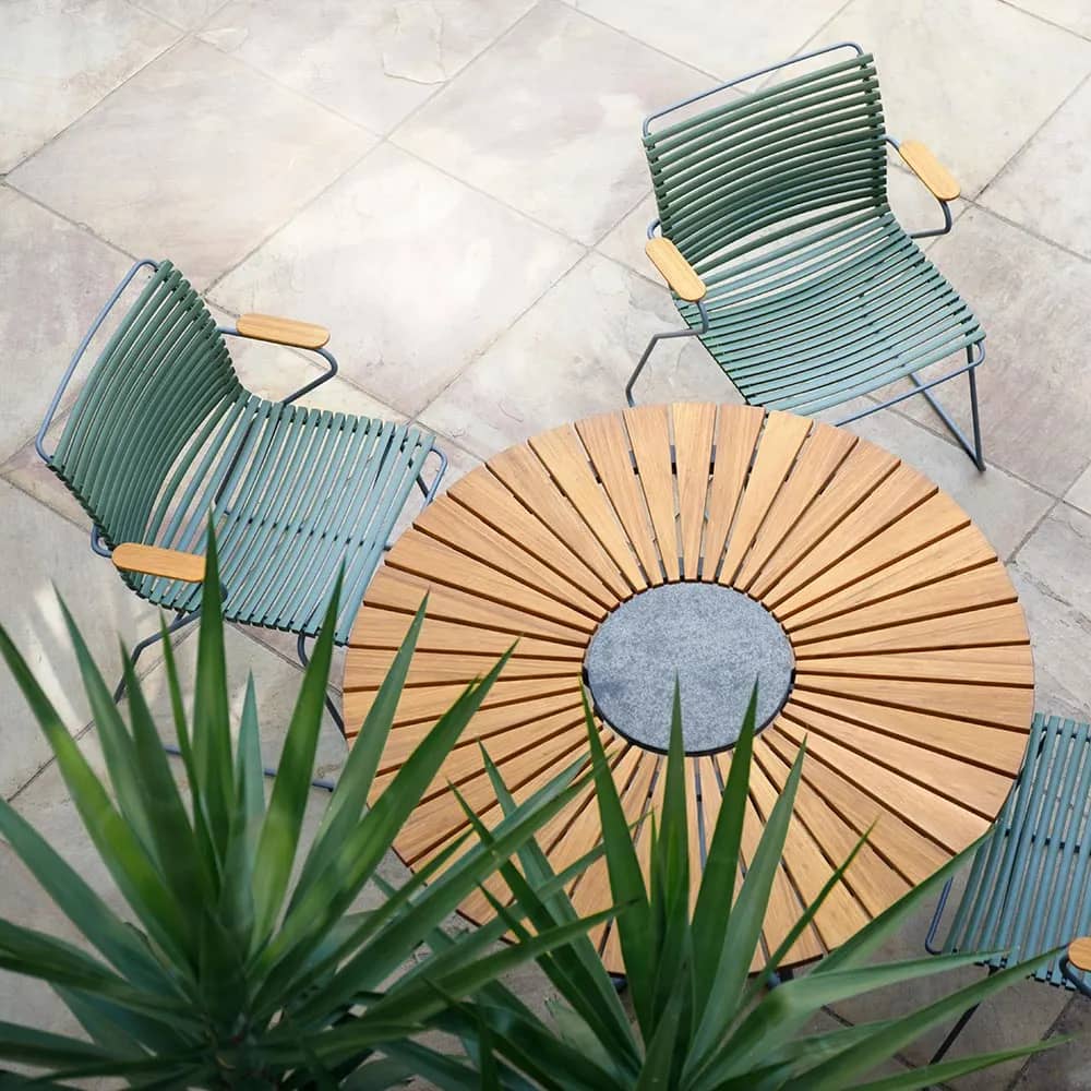 pine and bamboo: pine green click dining armchairs form a beautiful contrast with the red-orange bamboo of the circle dining table