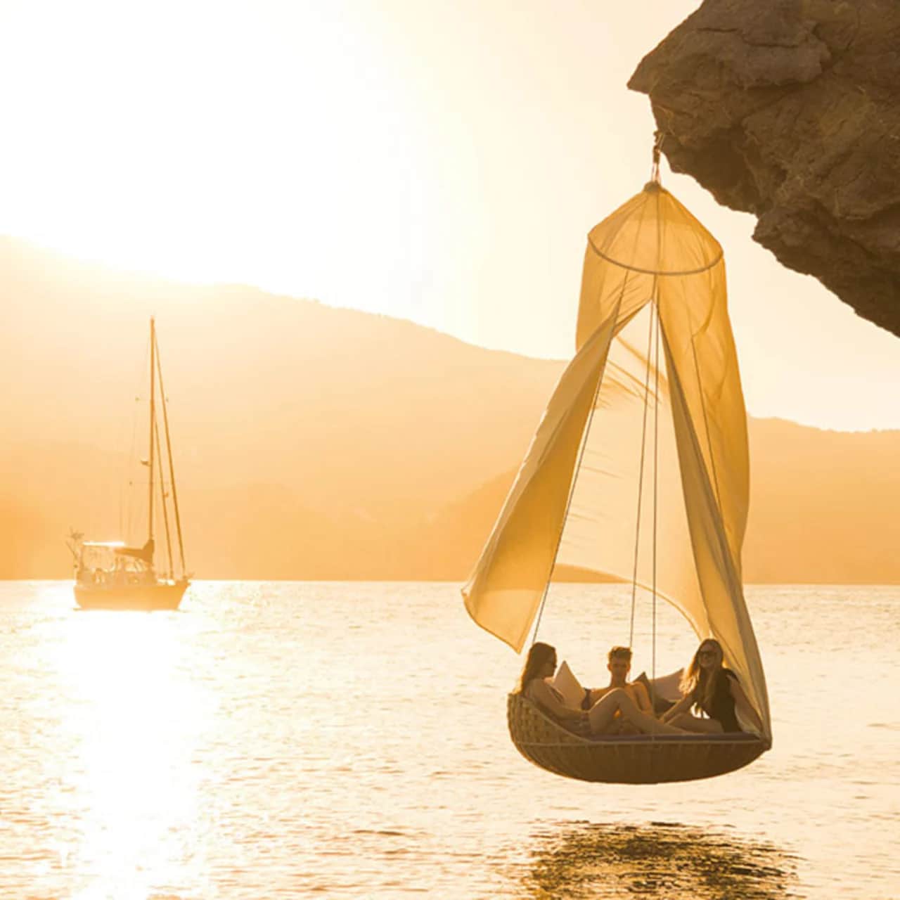 DEDON Island: A SWINGREST Hanging Lounger with canopy is the ultimate hanging lounge system (Photo courtesy of DEDON)