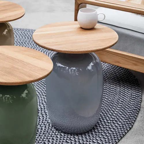 glazed ceramic side tables high and low with natural teak top</br><i>image provided courtesy of gloster furniture, inc.</i>