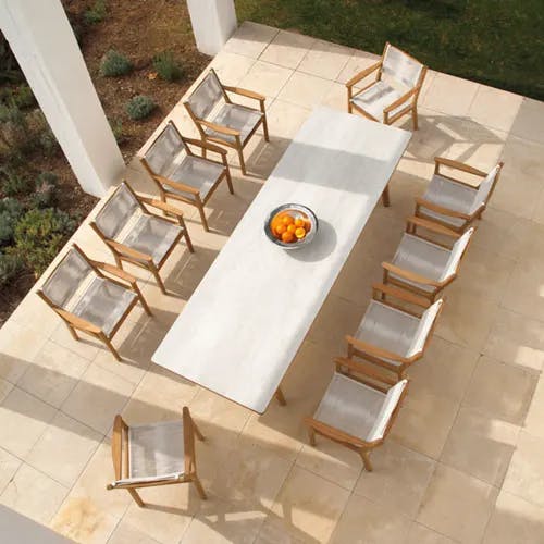 patio party: ten armchairs (chalk) around the 118" teak dining table with ceramic top (frost)