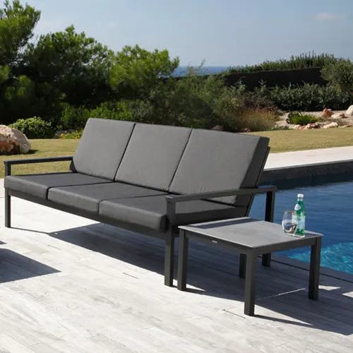 perfect match for outdoors: equinox 3-seater settee paired with armchair, ottoman and 20" low table all in graphite