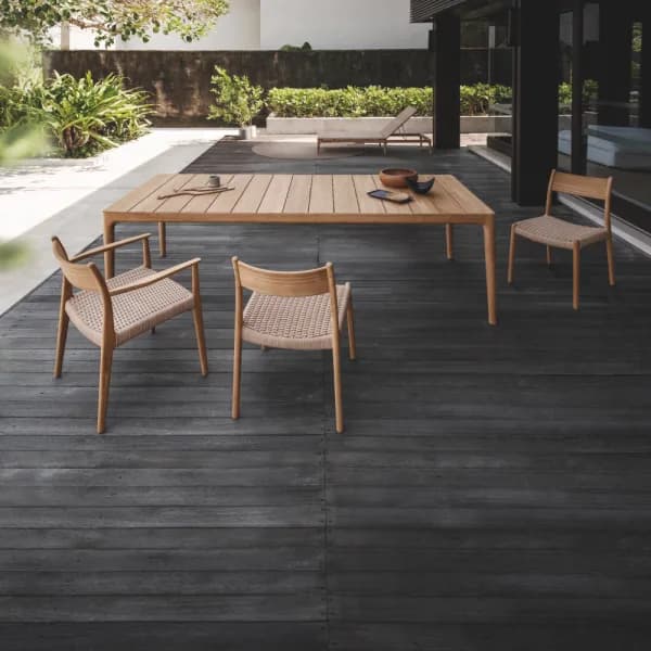 Slatted teak table top with dining armchairs and side chairs (Courtesy of Gloster)
