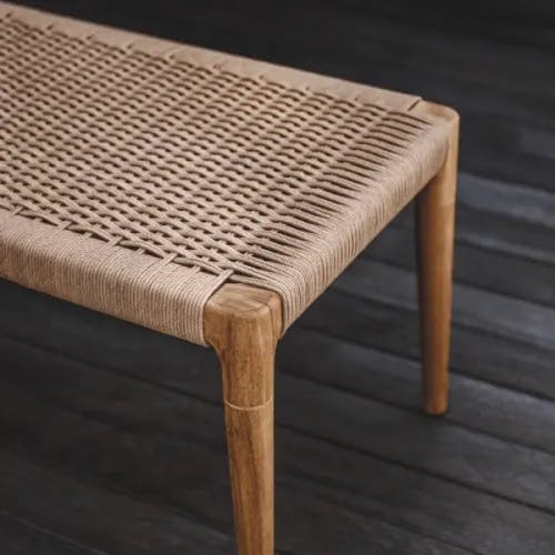 Close-up wheat wicker seat panel for dining bench (Courtesy of Gloster)